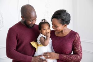 A man holding a baby alongside a woman